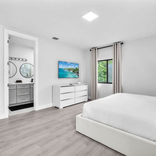 Relax in Bedroom 1 featuring a king-sized bed, ample closet space, a dressing table perfect for getting ready or working, plus your own ensuite bathroom.