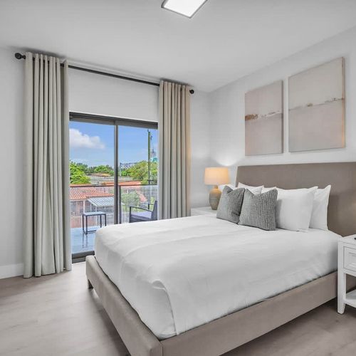 Bedroom 2 offers a queen bed and private balcony access for your comfort.