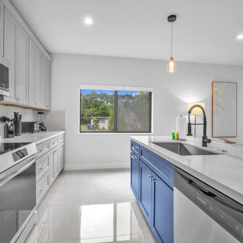 Spacious modern kitchen with a large island, plenty of storage, and all the essentials to cook your favorite meals during your stay.