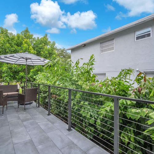 Spacious balcony with outdoor seating—great for coffee, reading, or simply relaxing after a day out in South Florida.