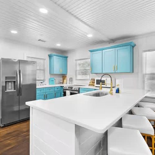 Fully renovated and fully equipped kitchen featuring elegant marble countertops and spacious cabinets to accommodate all your family's needs. Plus, a dedicated workstation for a seamless workcation experience.