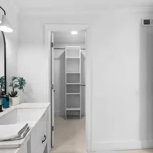 The bathroom is thoughtfully designed with his-and-hers mirrors, plenty of storage cabinets, and a spacious closet, offering both comfort and convenience for an extended stay or a relaxing getaway.