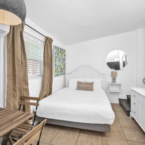 Cozy queen bed with clean linens and soft pillows for a comfortable night’s rest.