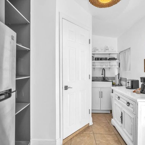 The unit includes a kitchenette with a refrigerator, microwave, coffee maker, air fryer, toaster, and sink (please note: no stove).