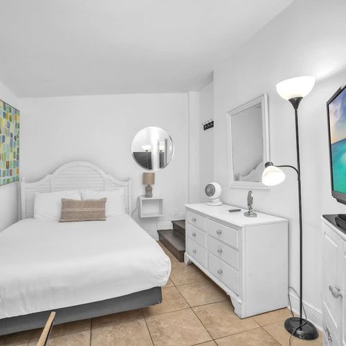 The unit includes a TV and a spacious dresser for your convenience.