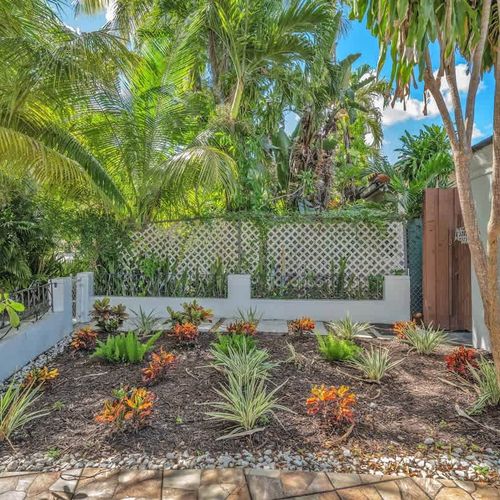 Private guest suite entrance surrounded by lush tropical landscaping, offering a peaceful and inviting South Florida welcome.