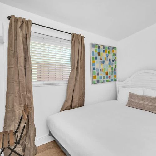 Cozy queen bed with clean linens and soft pillows for a comfortable night’s rest.