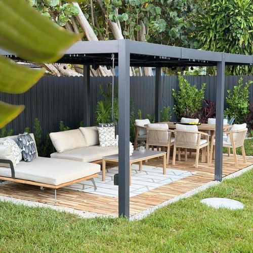 Stylish backyard cabana featuring comfortable seating and a dining area