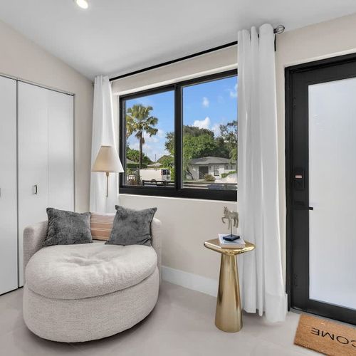 Living space with a window offering a beautiful view of the front yard.