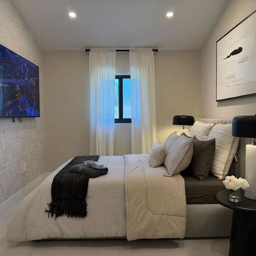 Cozy bedroom with a TV for your comfort and entertainment.