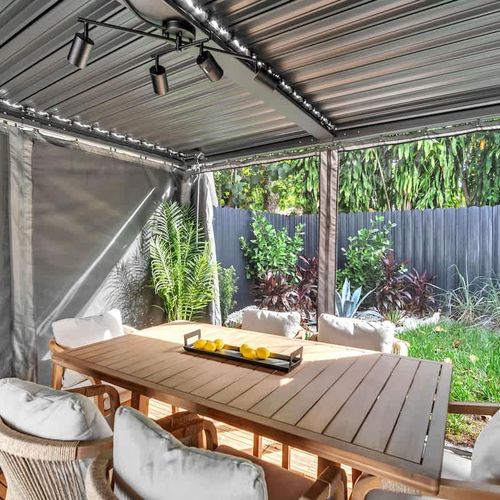 Dine al fresco in the backyard cabana for a relaxing outdoor experience.