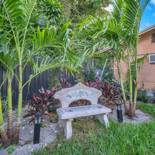 Relax on the small outdoor bench, perfect for enjoying the fresh air