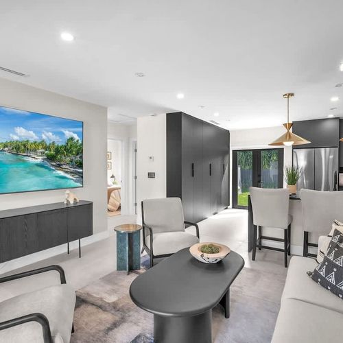 Inviting living room seamlessly connected to the kitchen, with easy access to the backyard