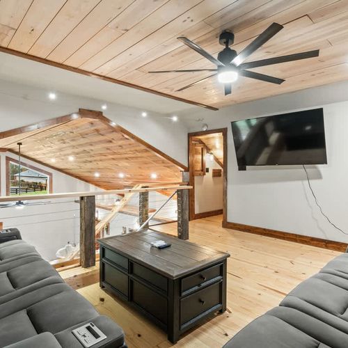 Charming loft lounge with comfortable seating, ideal for movie nights, catching up on TV, or unwinding after a day of exploring.
