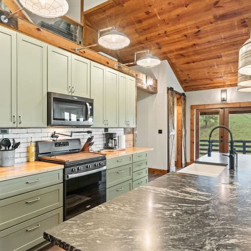 Spacious fully equipped kitchen with ample storage, stocked with all the essentials you need to prepare delicious meals for family or friends