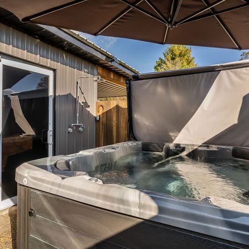 Unwind and soak in the relaxing hot tub, perfect for a peaceful evening after a day of exploring.