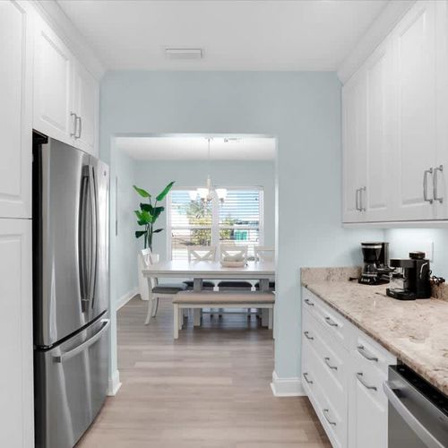 Cook and dine with ease in this spacious kitchen, featuring ample storage, a sleek granite countertop, and a full fridge—perfect for both short getaways and extended stays.