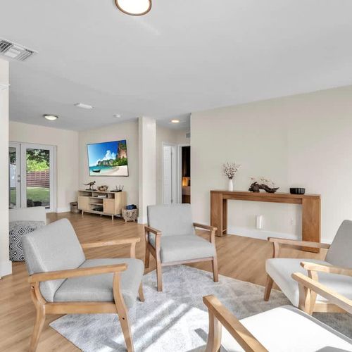 Enjoy a beautifully designed open-plan living and dining area featuring contemporary décor, light wood floors, and an airy, serene vibe.