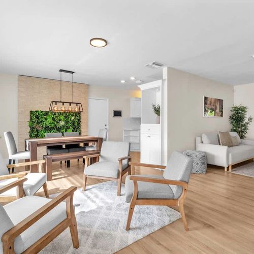 Enjoy a beautifully designed open-plan living and dining area featuring contemporary décor, light wood floors, and an airy, serene vibe.