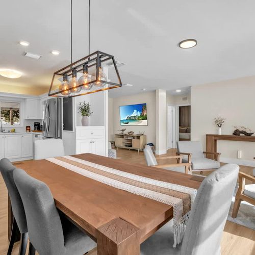 Enjoy meals in a bright, open dining area with elegant wood finishes, cozy chairs, and a clean, modern design.