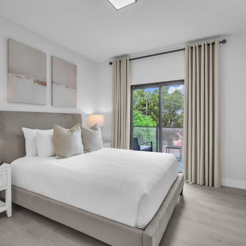 Bedroom 4 offers a queen bed and private balcony access for your comfort.
