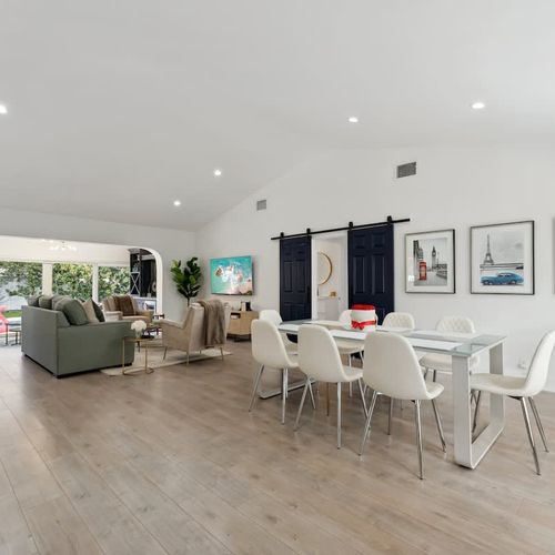 Spacious dining space featuring a sleek table with comfortable seating that can accommodate up to 8 guests.