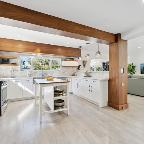 Modern open kitchen with a spacious breakfast bar, comfortable counter seating, and stylish pendant lighting—perfect for casual meals and conversation.
