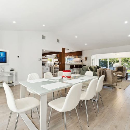Spacious dining space featuring a sleek table with comfortable seating that can accommodate up to 8 guests.