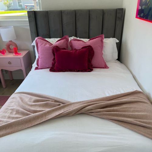 Comfortable shared bedroom offering two double beds with layered bedding and a warm, welcoming feel.