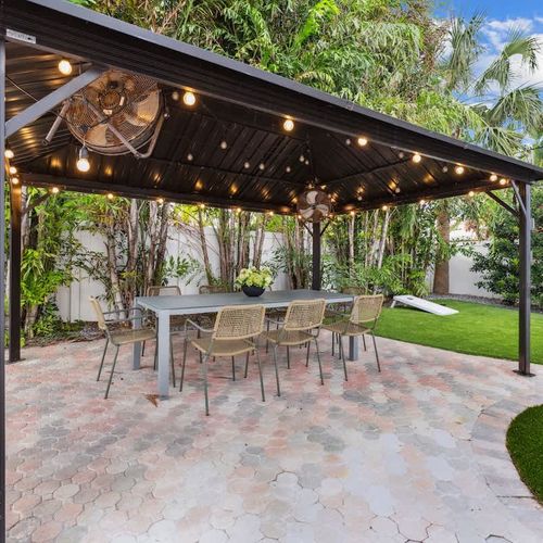 Shaded patio ideal for coffee in the morning, relaxing afternoons, and evening meals illuminated by soft string lights.