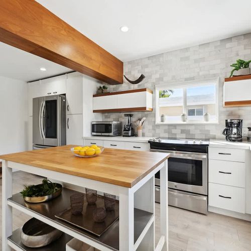 Inviting open kitchen area with spacious island, modern amenities, and plenty of room for meal prep, ideal for longer stays or family use.