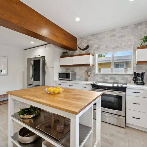 Inviting open kitchen area with spacious island, modern amenities, and plenty of room for meal prep, ideal for longer stays or family use.