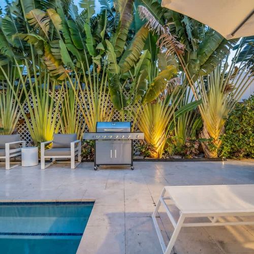 Enjoy poolside barbecues under the shade of beautiful palm trees.