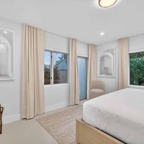 Bedroom 3 - King - Relax in Bedroom 2, featuring sunlit windows and curtains for a peaceful atmosphere.