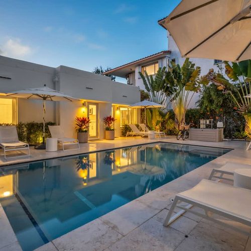 Evenings come alive with warm lights and a tranquil poolside setting.