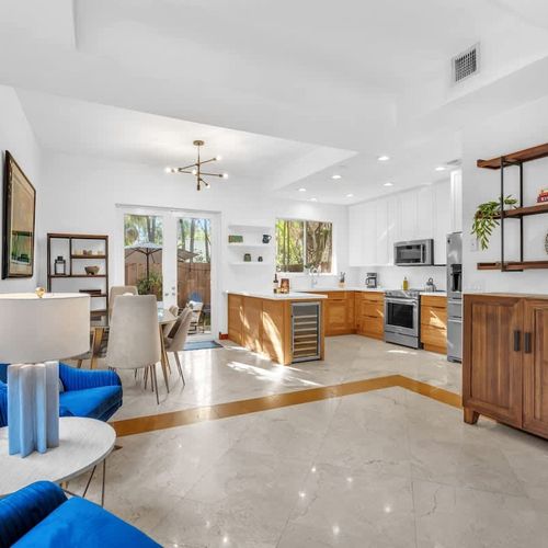 “Fully equipped kitchen with a dining table, extra seating, and just a few steps to the backyard.