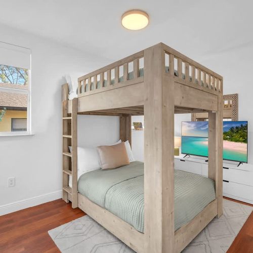 Rest easy in this cozy space, complete with a convenient bunk setup, smart TV, and plenty of natural light.
