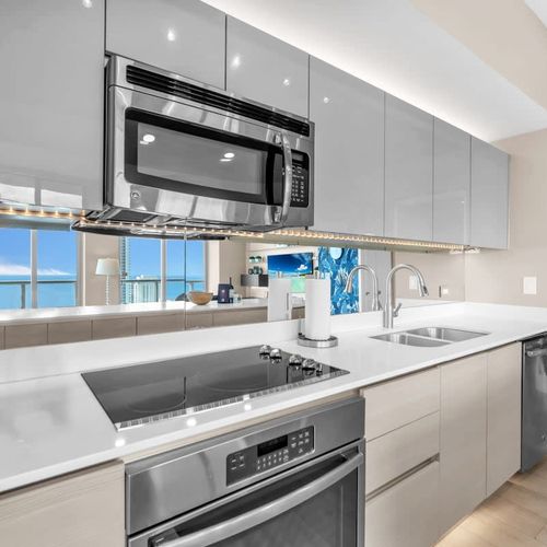 Fully equipped gourmet kitchen with stainless steel appliances, sleek cabinetry, and a spacious island perfect for cooking and entertaining.