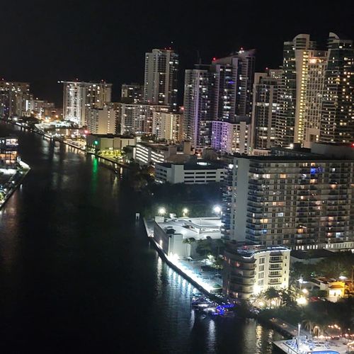 Experience the magic of the city at night with beautiful lights stretching across the skyline and canals.