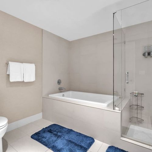 Well-appointed bathroom with a soaking tub, walk-in glass shower, and dual sinks designed for comfort and convenience.