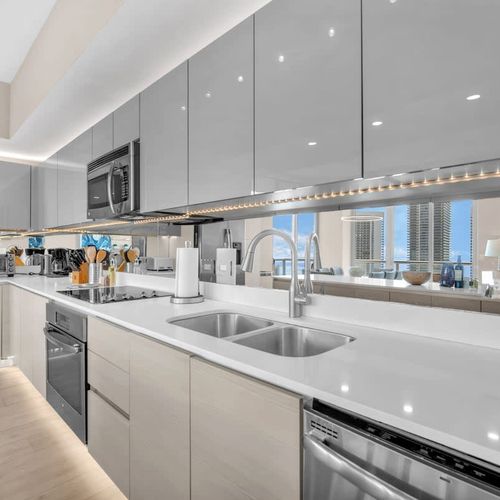 Fully equipped gourmet kitchen with stainless steel appliances, sleek cabinetry, and a spacious island perfect for cooking and entertaining.