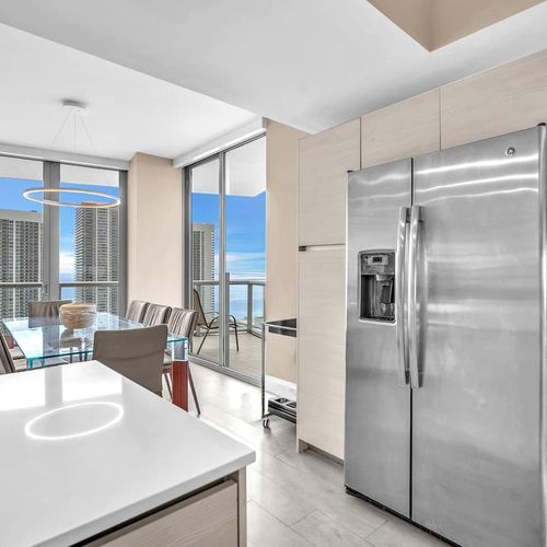 Full-size stainless steel refrigerator with built-in water and ice dispenser, offering plenty of storage for groceries and drinks.