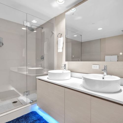 Well-appointed bathroom with a soaking tub, walk-in glass shower, and dual sinks designed for comfort and convenience.