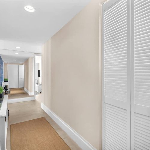 Unit entrance with a stylish entryway that leads directly into the living space and kitchen.