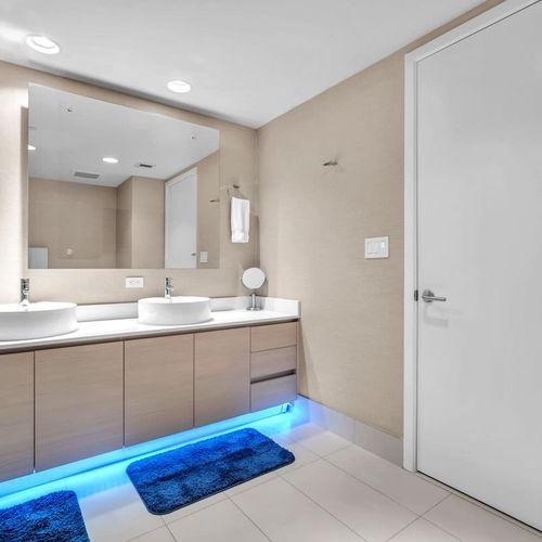 Well-appointed bathroom with a soaking tub, walk-in glass shower, and dual sinks designed for comfort and convenience.