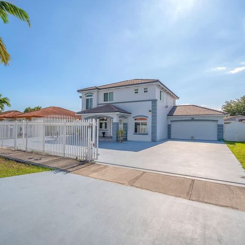 Clean, well-maintained exterior with attached garage and ample outdoor space.