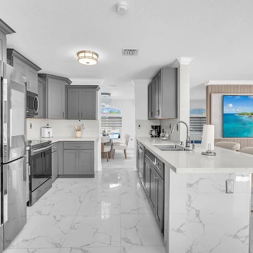 Spacious modern kitchen with stainless steel appliances, quartz countertops, and a large island perfect for cooking and gathering.