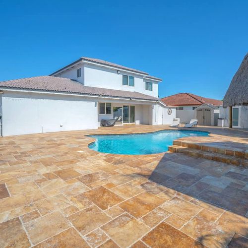 Spacious backyard with a private pool and plenty of room to relax or entertain.