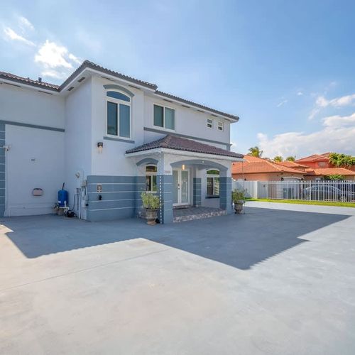 Spacious two-story home with a large private driveway, fenced yard, and sunny outdoor space—perfect for relaxing or entertaining.