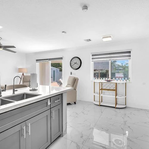 Bright kitchen with oversized island, double sink, and plenty of prep space for meals and snacks.